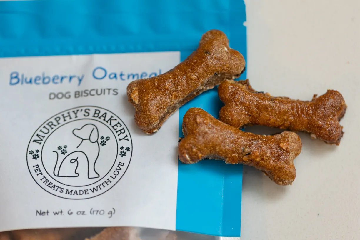Bone-shaped blueberry oatmeal biscuits on a Murphy’s Bakery bag